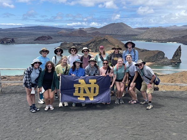 Galápagos course students and instructors on cinder cone overlooking Pinnacle Rock on Bartolomé Island.